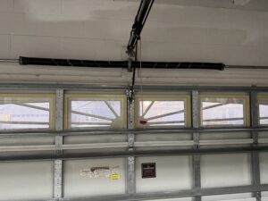 Garage door with torsion spring system above door ready for replacement